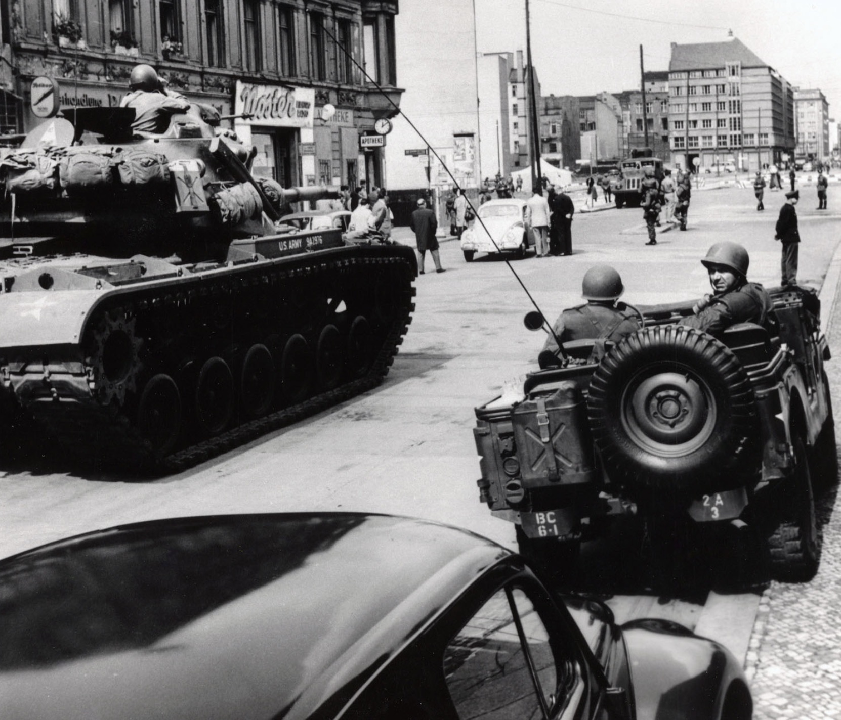 American tanks face an East German water cannon at Checkpoint Charlie 
